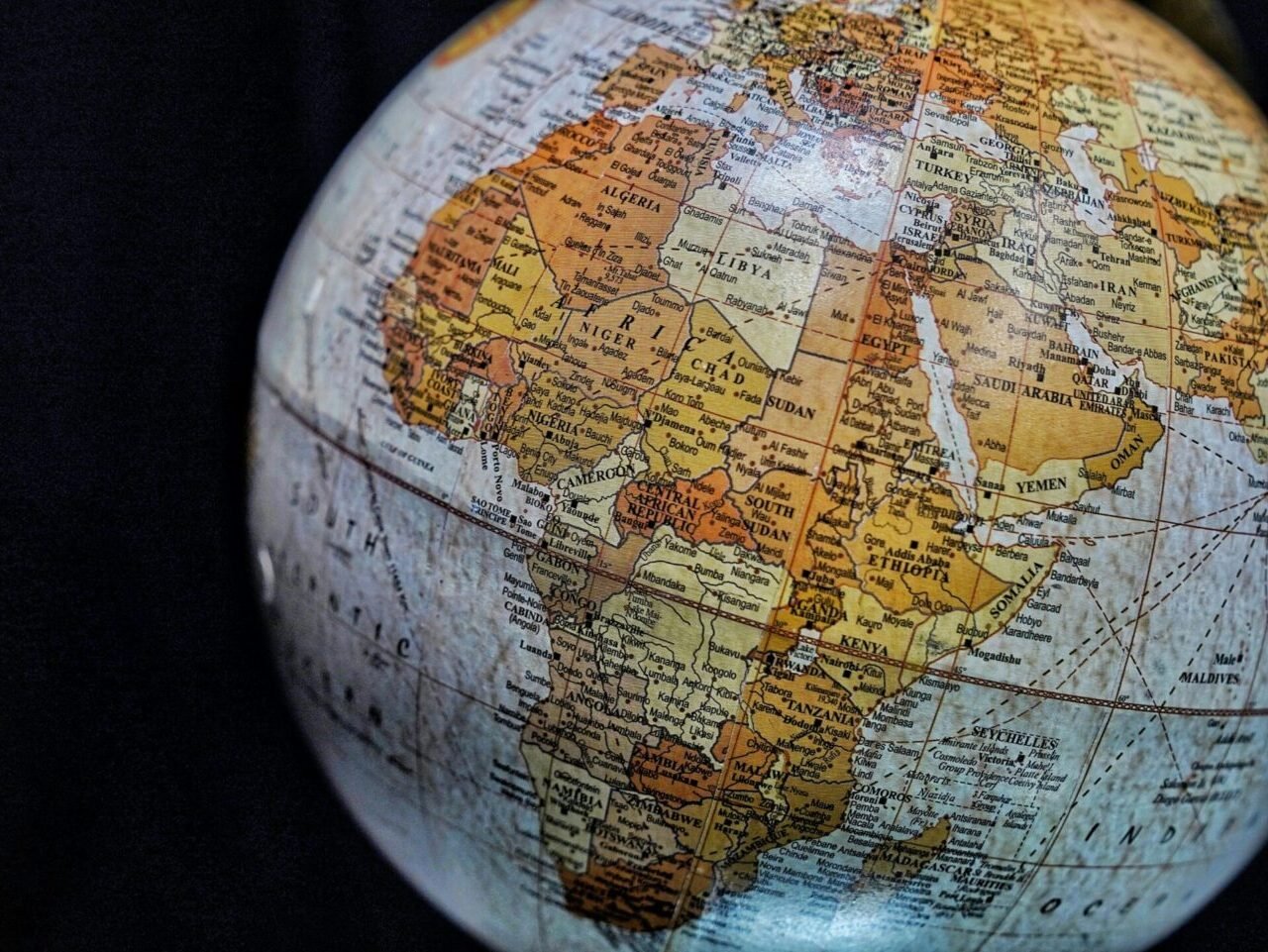 Close-up of a vintage globe highlighting Africa and the Middle East with intricate geography details.