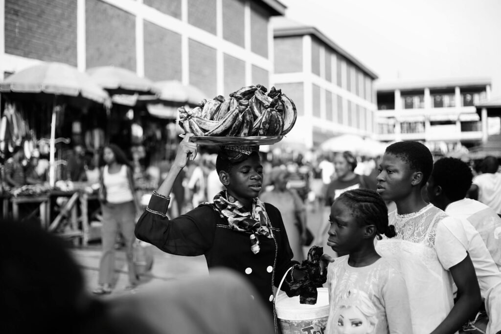 Black and white photo capturing vibrant street market life in Abuja, Nigeria.